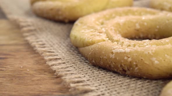 Round shortbread cookies on a burlap tablecloth. On a wooden old table