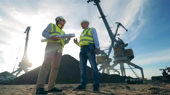 Two Engineers Are Discussing a Project in the Quarry Zone