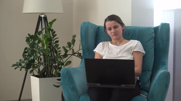 Authentic Young Woman Chatting On Laptop In Living Room