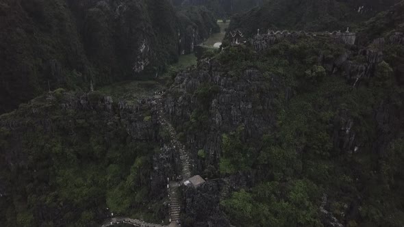 Ancient Stairs to Buddhist Temple on Mountain at Calm River in Ninh Binh