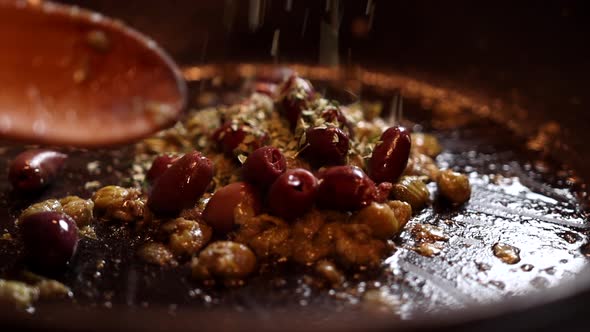 Spices sprinkled to pan fried italian dish