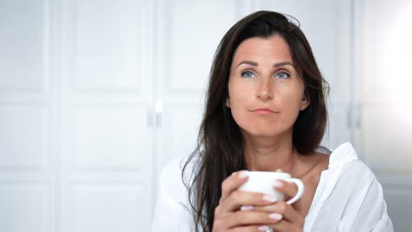 Portrait Friendly Pensive Woman Drinking Tea or Coffee Enjoying Morning at Home or Hotel Interior