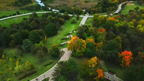 Flight over the autumn park in cloudy weather.