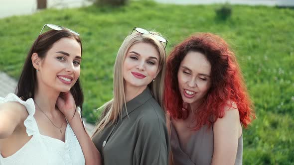 Group of Adorable Fashion Woman Posing Taking Selfie Together at Summer Park Medium Closeup