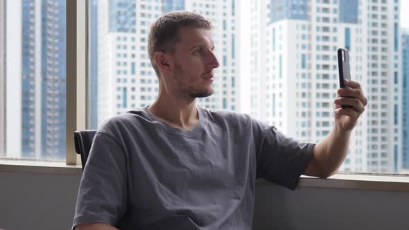 A Young White Manager in the Office Discussing His Ideas with a Remote Colleague on a Video Call