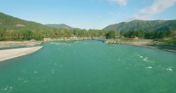 Low Altitude Flight Over Fresh Fast Mountain River with Rocks at Sunny Summer Morning