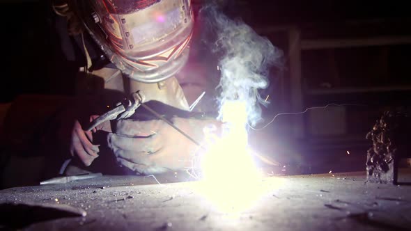 Welder working on a piece of metal