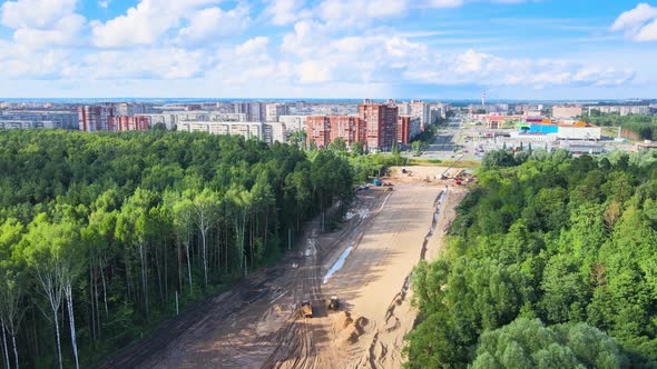 Construction of a new highway. Sand embankment preparation by road machinery