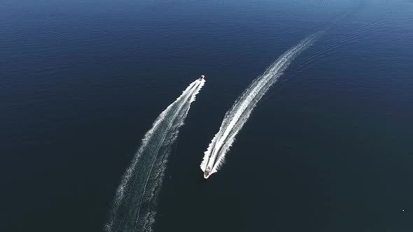 Aerial Drone Shot of Two White Speed Boat Sailing in Blue Sea