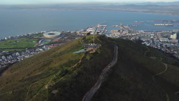 Drone shot of Signal Hill in Cape Town - drone is circling around Signal Hill, facing Green Point an