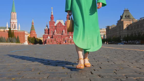 Girl in a green dress on Red Square, slow motion