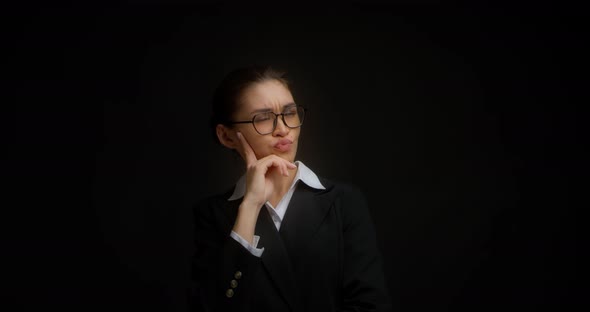 Thoughtful Businesswoman Touches Her Chin Ponders Ideas and Strategies