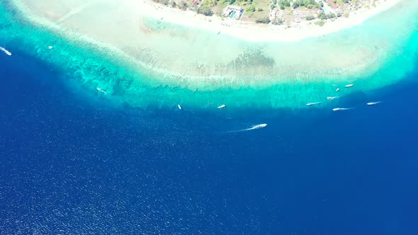 Aerial above landscape of marine tourist beach holiday by transparent lagoon and white sand backgrou