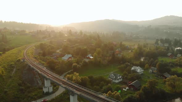 Mountain Village in Valley and Railway Bridge