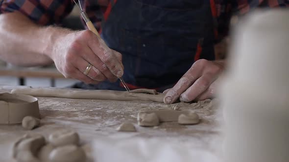 Caucasian Male Hands Making Decoration From Clay