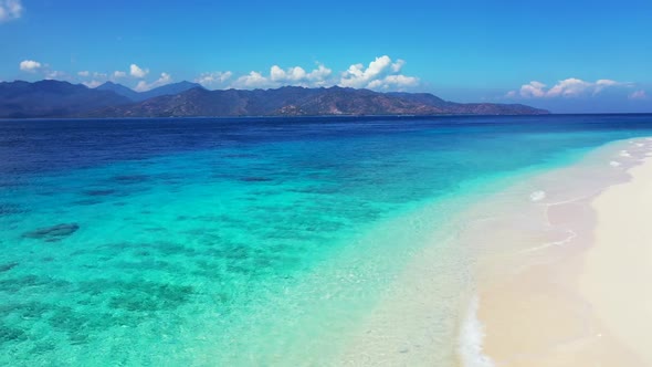 Aerial flying over seascape of perfect bay beach vacation by turquoise ocean and clean sand backgrou