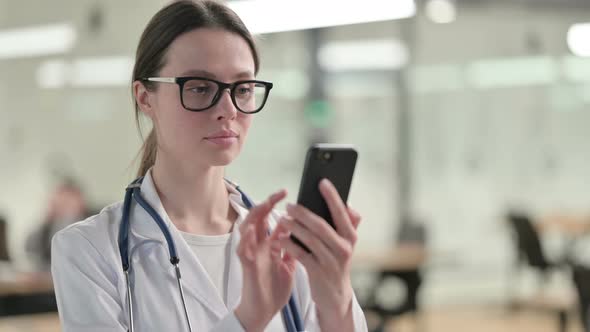 Portrait of Young Female Doctor using Smartphone