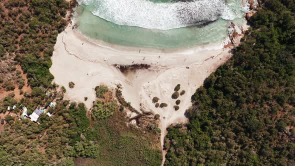 Aerial View of White Sand Beach Blue Sea Marine Vegetationwavestrees and Red Rocks