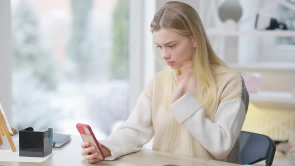 Middle Shot of Focused Attractive Deaf Woman Using Smartphone for Video Chat Talking in Sign