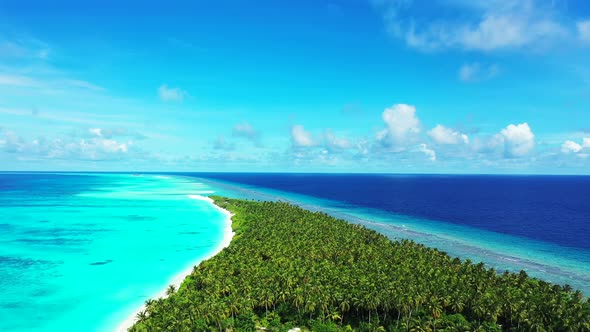 Luxury above clean view of a white sand paradise beach and blue sea background in hi res 4K