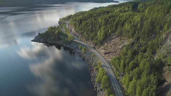 Flying Over Road with Car and Kroderen Lake Shore in Norway