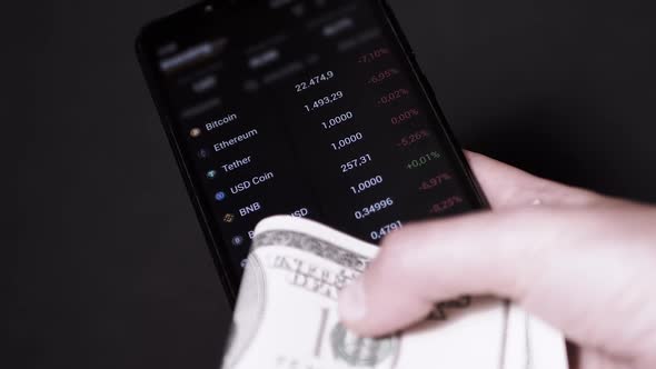 Businessman is Viewing Quotes Data Price of a Cryptocurrency on a Smartphone