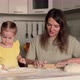 Cheerful Mother and Little Daughter Prepare Food From Dough and Flour - VideoHive Item for Sale