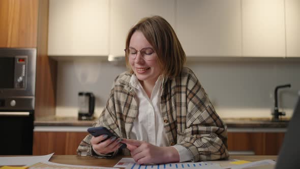 Businesswoman Holding Modern Smart Phone Texting Message in Office