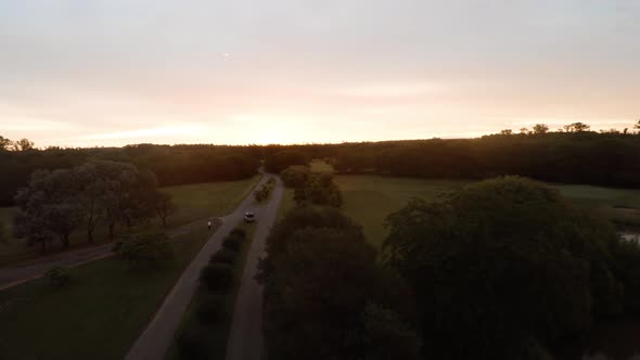 Aerial view of road through tranquil countryside at dusk