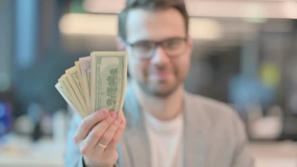 Portrait of Confident Casual Man Holding Dollars