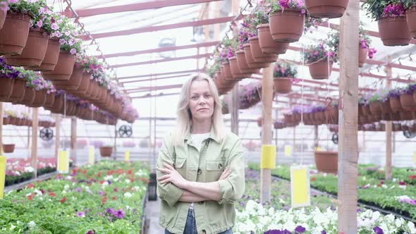 woman gardener Happy farmer works in flower shop takes care of flowers