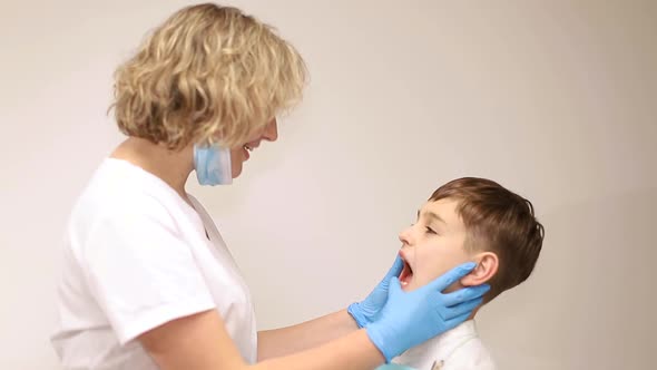 Dentist examines the baby teeth. Painless dental treatment, caries in children