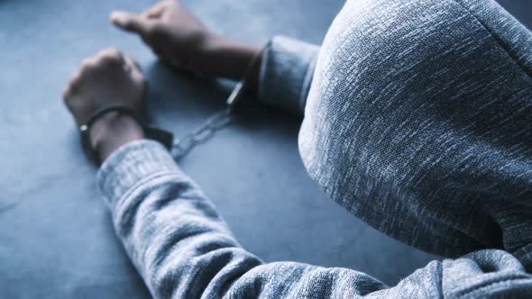 Man's Hand with Handcuff on Black Background