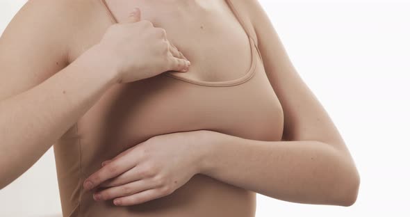 Woman Checking Her Breast for Signs of Breast Cancer