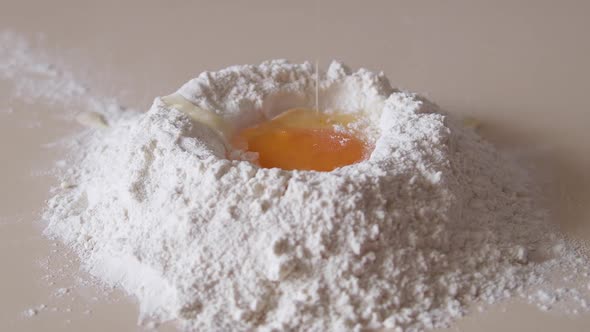 Slow Motion of Falling Eggs Into Flour Stock. Footage Food. Egg Dropping Into Flour, Slow Motion