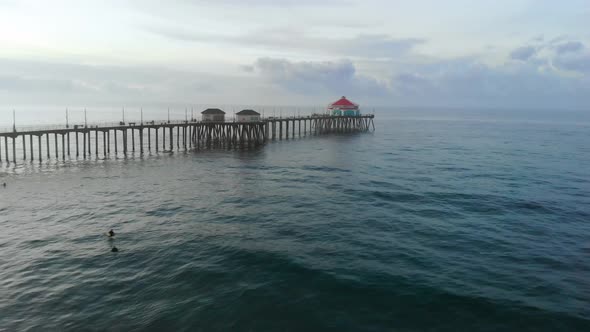 A 4k  ariel view moving towards the Huntington Beach pier in California Surf City USA at sunrise as