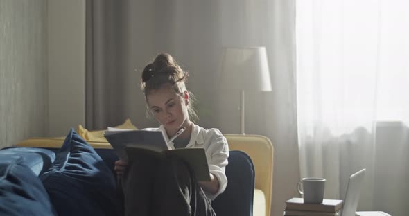 Student Typing on Laptop and Studying at Home