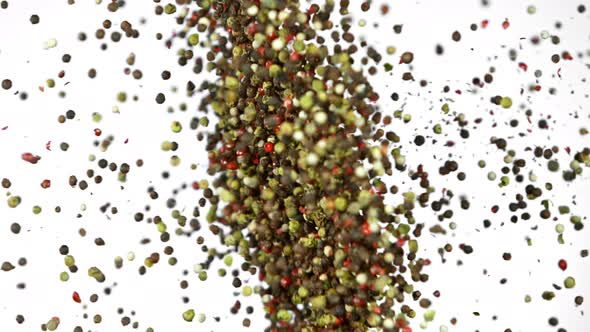 Super Slow Motion Shot of Pepper Seasoning Side Collision Isolated on White Background at 1000Fps