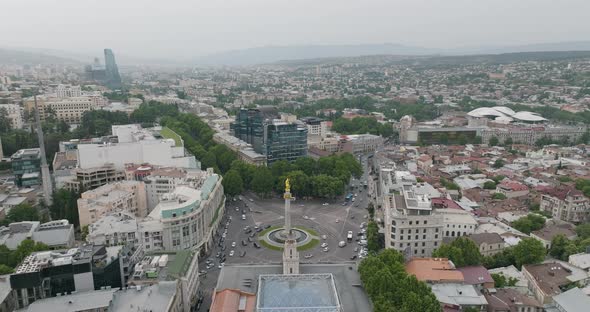 Cityscape of Tbilisi, including Saint George statue and the Freedom Square.