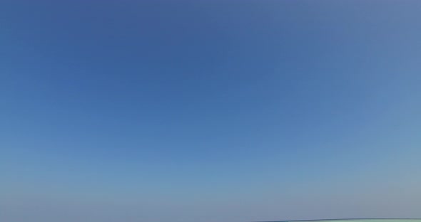 Natural birds eye island view of a sunshine white sandy paradise beach and aqua blue ocean backgroun