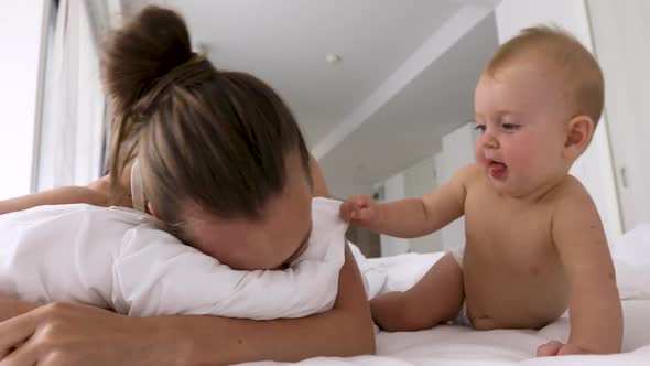 Little Baby Wakes Up Sleeping Mother