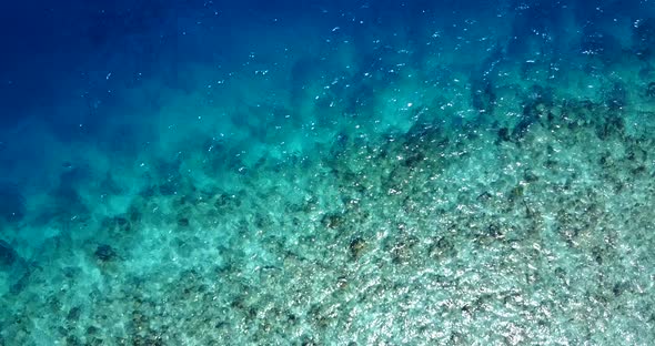 Tropical flying abstract shot of a sunshine white sandy paradise beach and turquoise sea background 