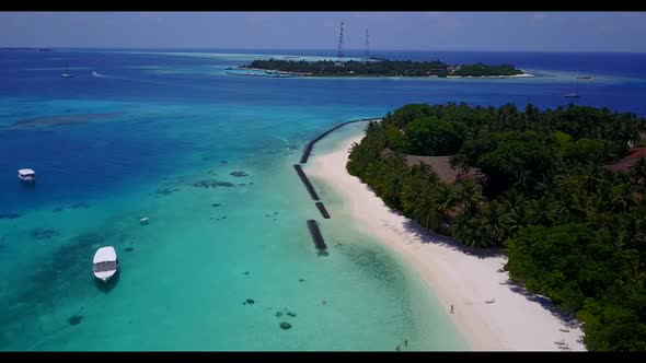 Aerial scenery of tranquil coastline beach time by shallow water and white sand background of a dayo