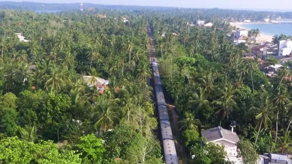 Slow Motion Aerial Shot the Old Train Rides Through the Tropics