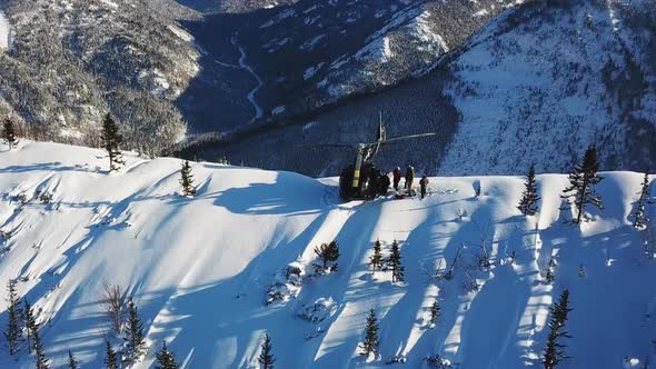 Actionsportlers were dropped by a helicopter at the top of the mountains