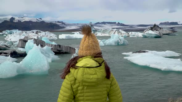 Tourist on Iceland Looking at Jokulsarlon Glacier Lagoon