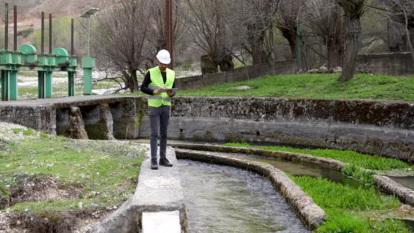 Engineer Investigates in Electric Water Dam