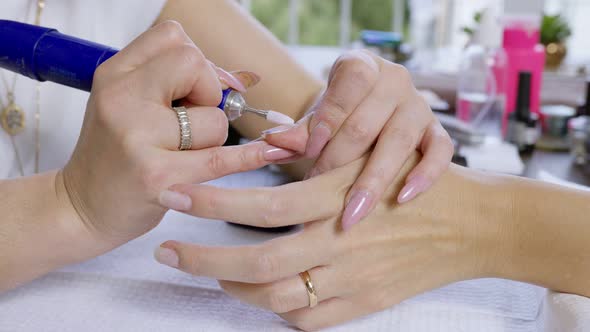 Manicurist Removing Cuticle.