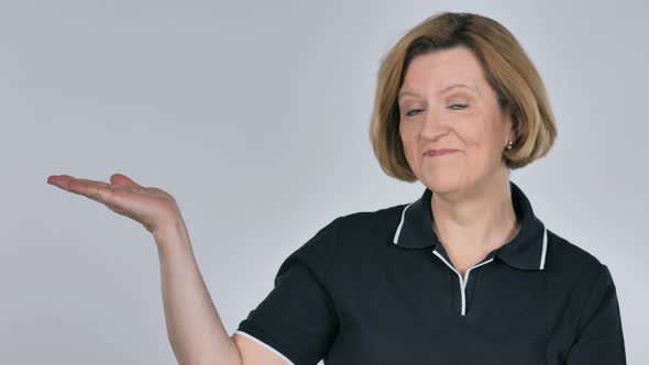 Portrait of Woman Showing Product at Side White Background