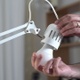 Man Replacing Old Filament Bulb With New Led Bulb  - VideoHive Item for Sale